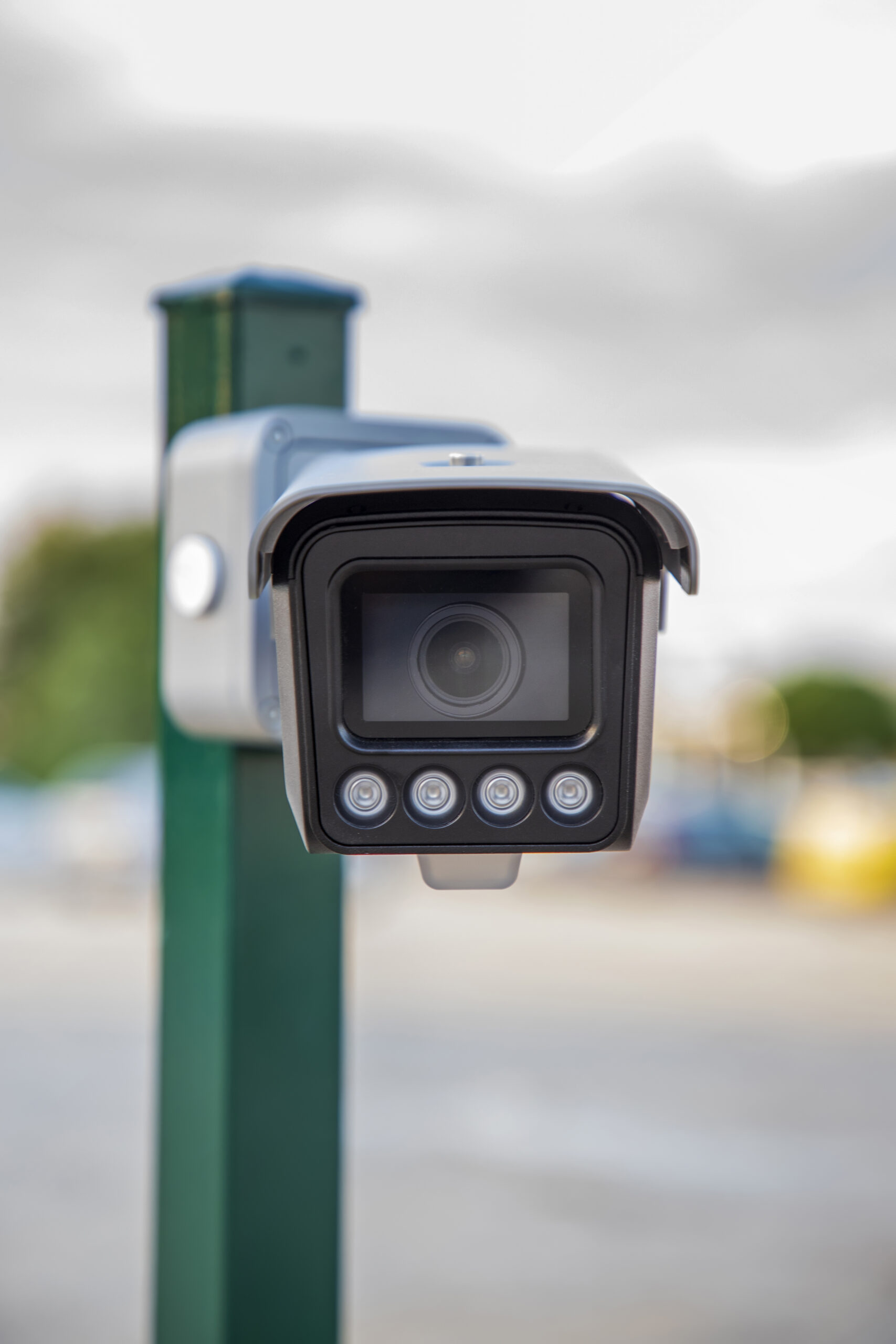 High-accuracy ANPR camera system by Currainlive capturing vehicle license plates in real-time at a commercial office building entrance.