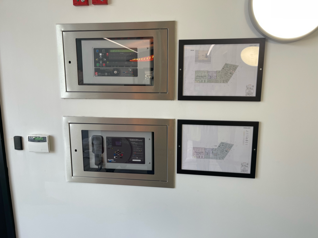 A professional fire alarm control panel (FACP) installed in a commercial building in Coventry, serving as the central hub for life safety systems.
