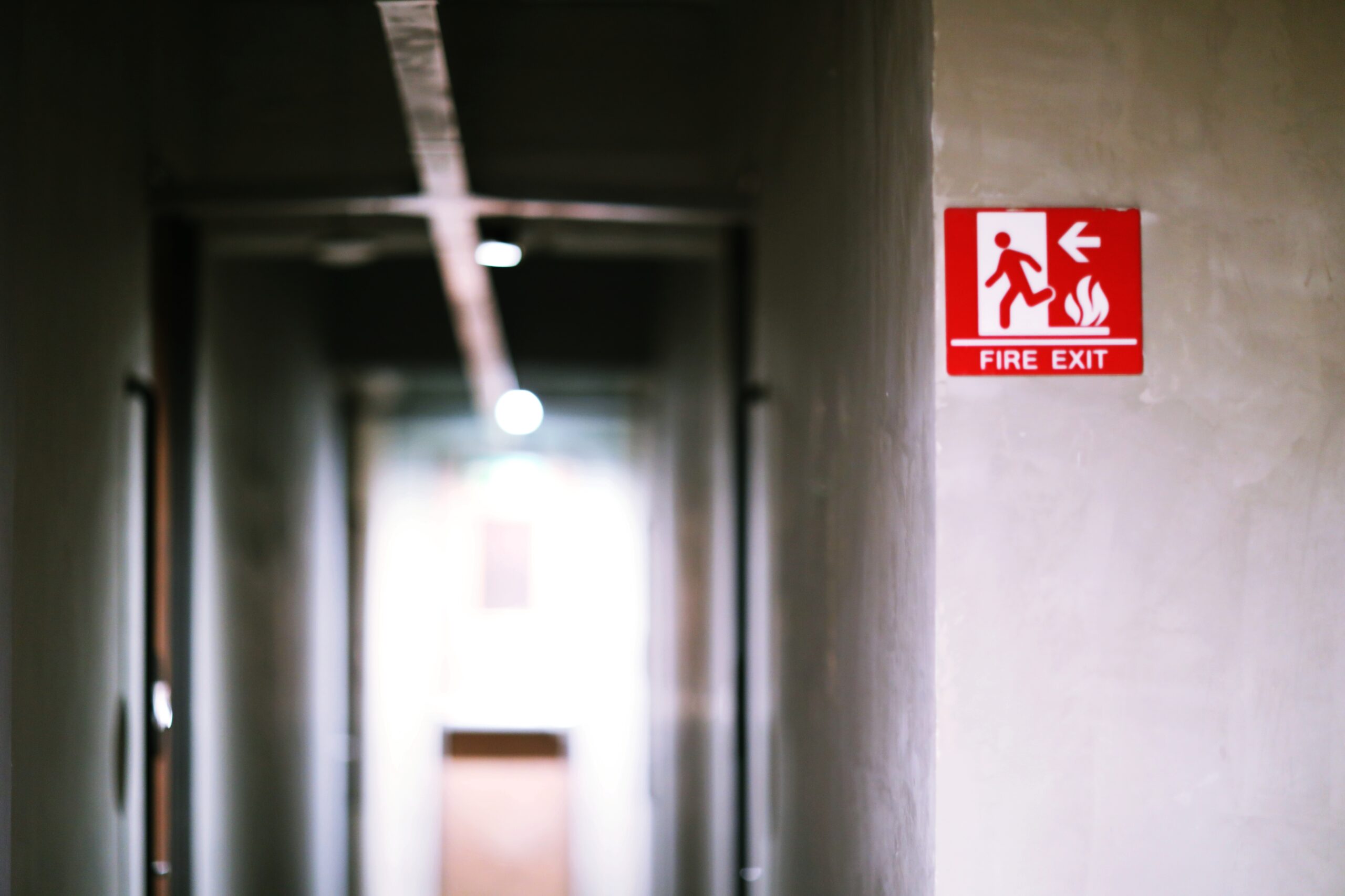 A commercial building in Coventry featuring clear fire exit signage and professional fire stopping measures to ensure safe evacuation routes.
