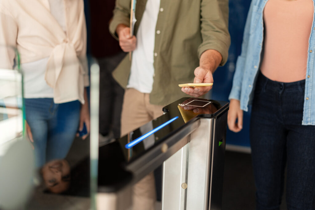 High-speed security turnstile being accessed via a secure credential, part of a remote-managed entry system for professional office buildings.