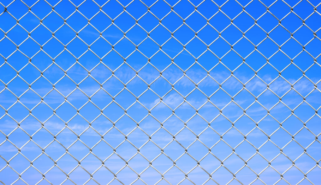 High-performance impact-dampening ball stop fencing designed to absorb energy and reduce noise in a Coventry sports facility.