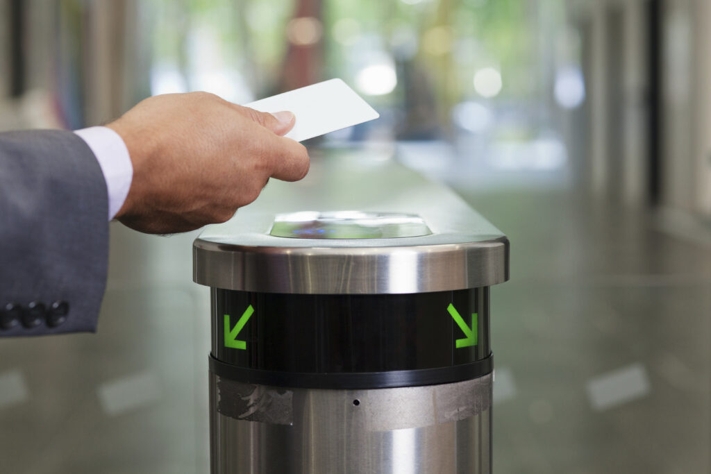 High-speed optical speed gates with advanced infrared sensors for rapid pedestrian flow and secure access control in a corporate lobby.