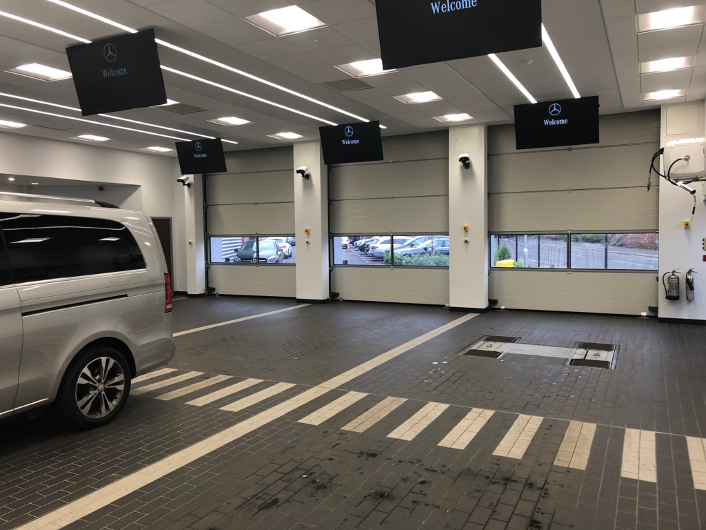 A luxury car safely parked in a garage protected by an automatic security gate system in Coventry, ensuring maximum vehicle safety.