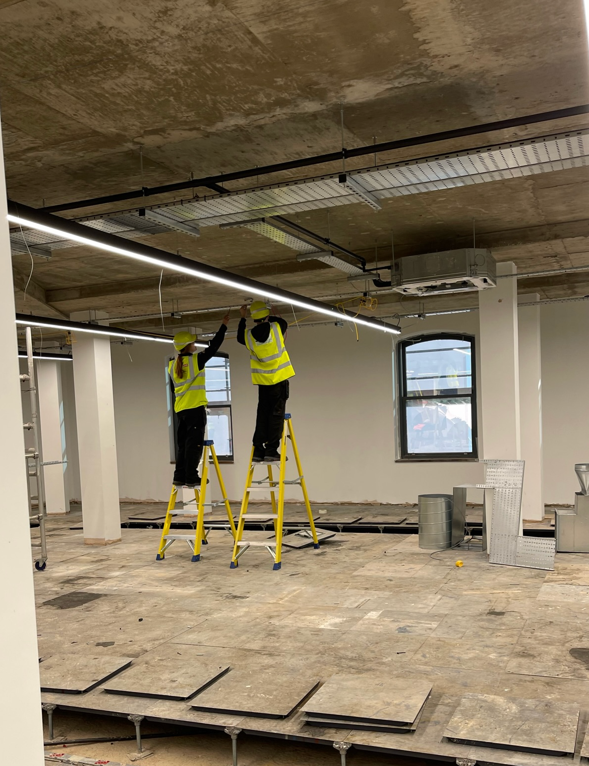 Experienced staff fitting a monitored electric perimeter fence system, ensuring all safety warning signs and UK regulations are met in the Midlands.
