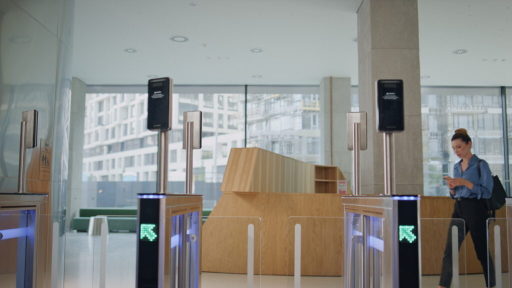 Security speed gate integrated with a visitor management system for streamlined guest check-in and authorized access at a commercial entrance.