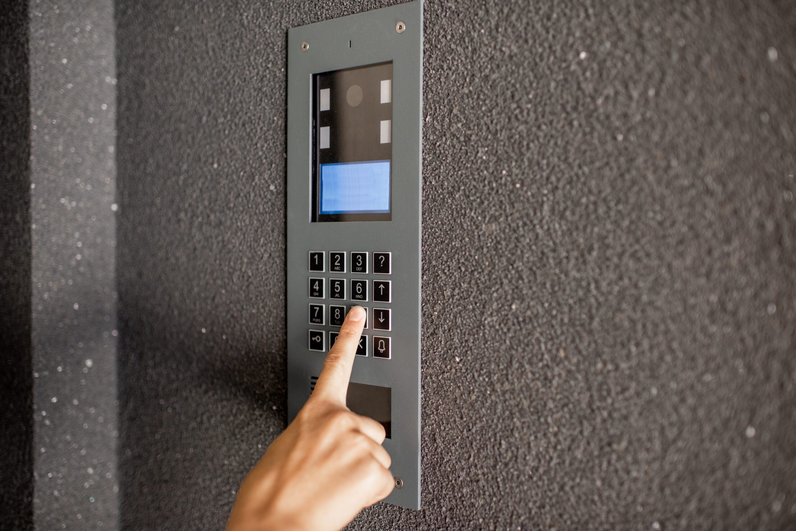 High-definition video entry intercom mounted at a commercial entrance, allowing staff to verify visitors visually before granting access.