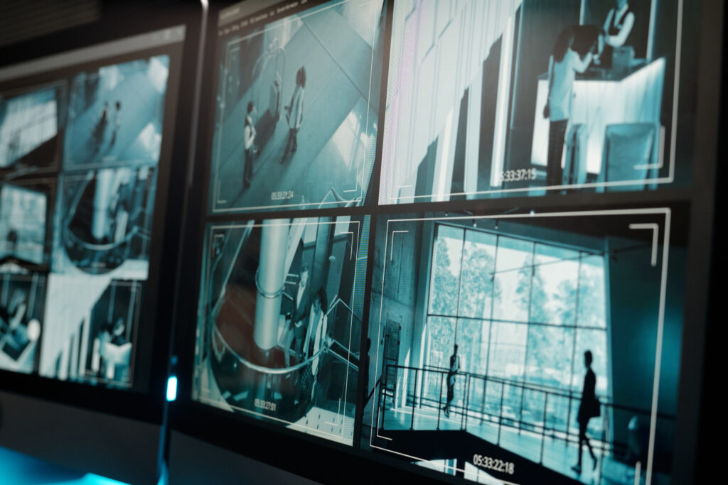 Professional security personnel monitoring live CCTV footage in a 24/7 control room for commercial property protection.