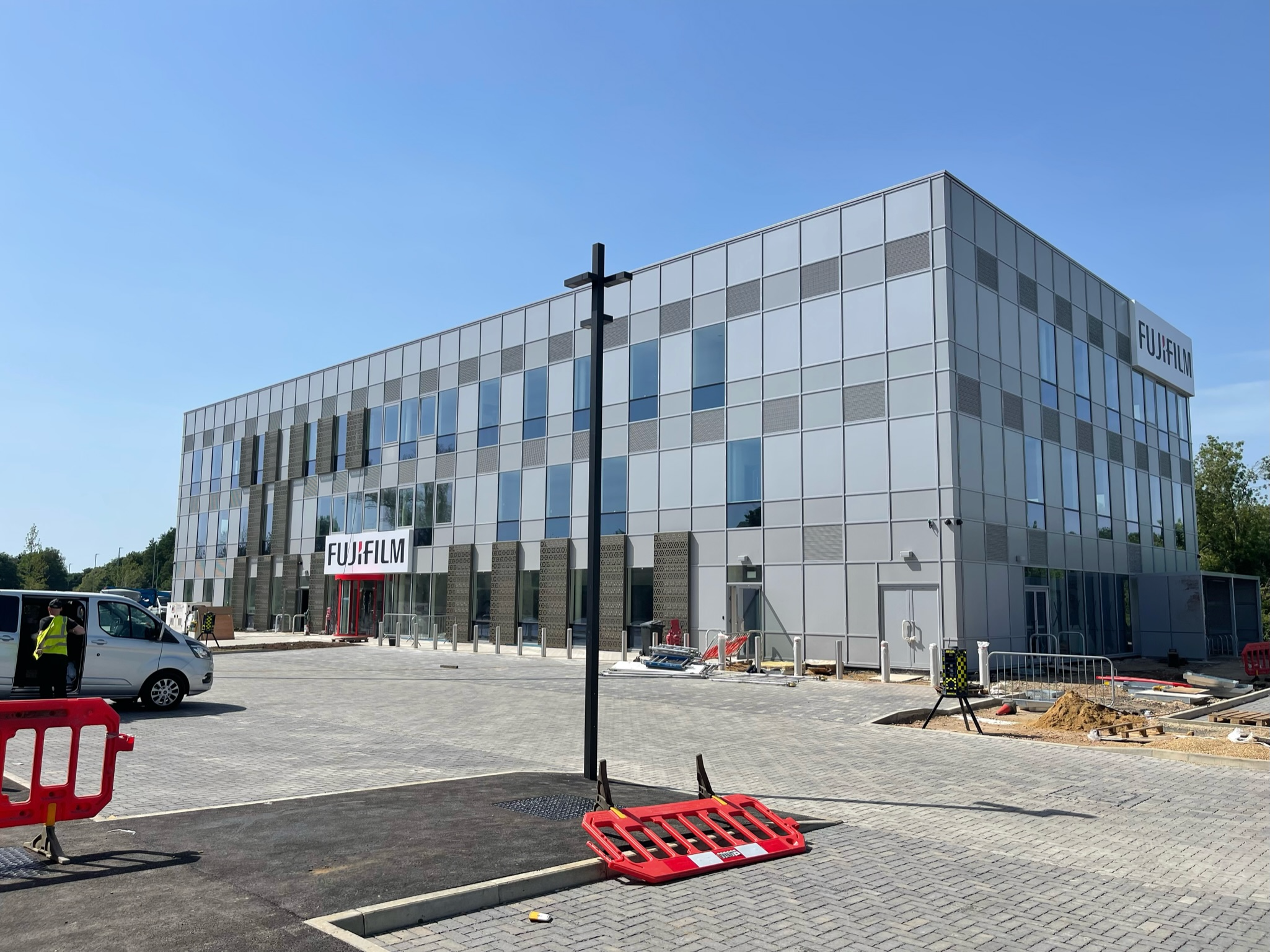Modern commercial bin storage building featuring reinforced security doors for waste management.