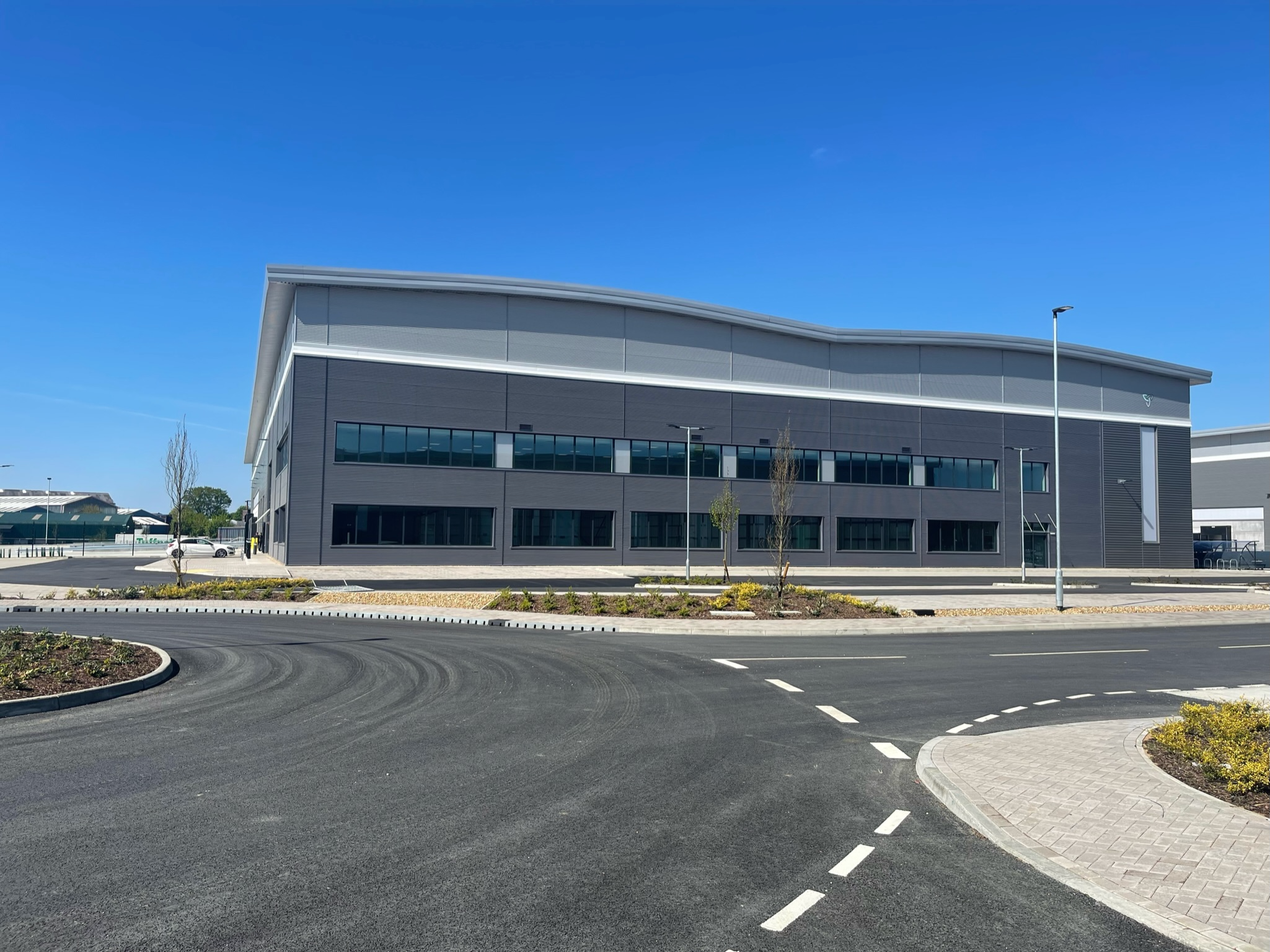 Exterior view of a secure commercial bin store installation at a business site in Coventry.